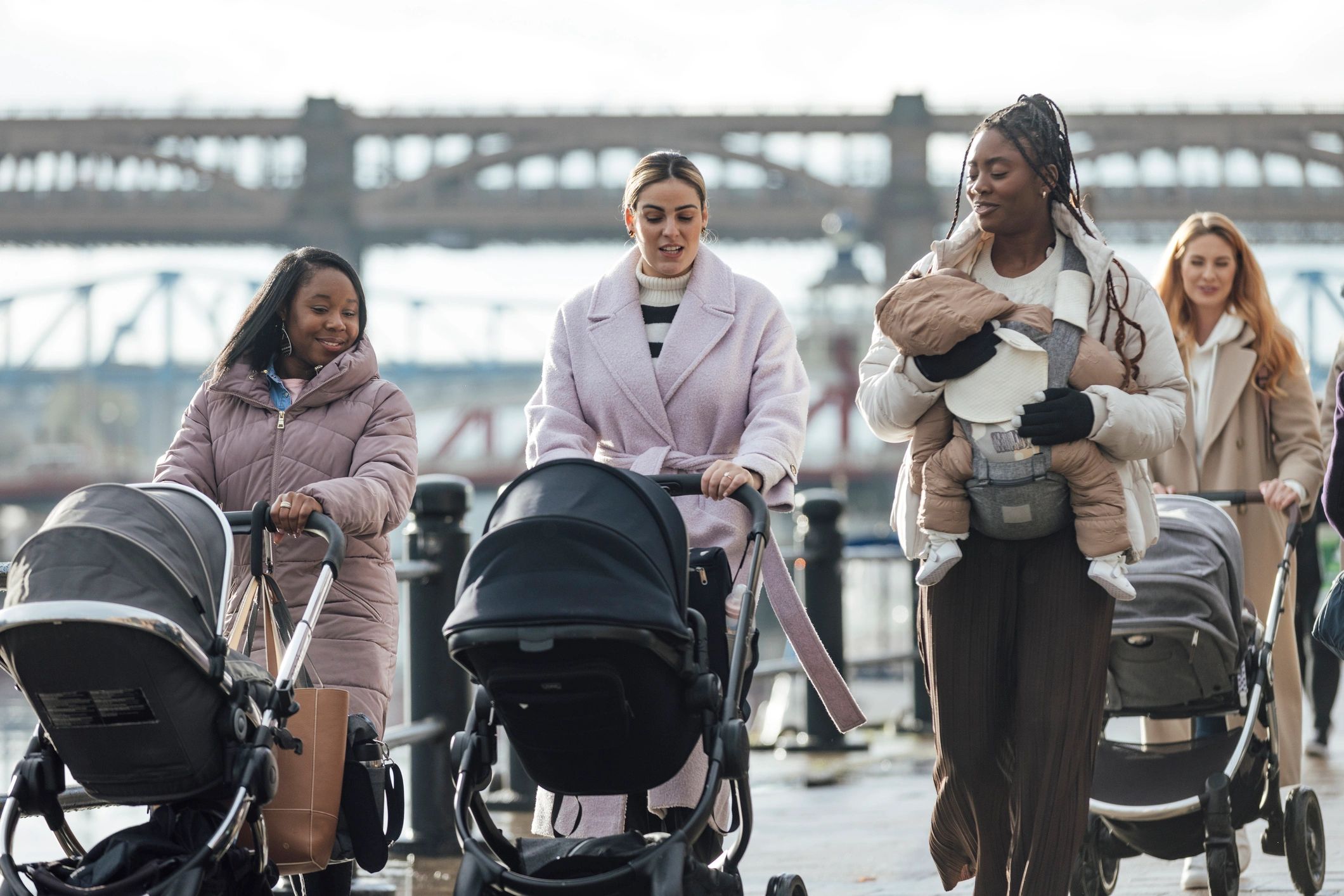 Parents walking with babies and strollers outdoors