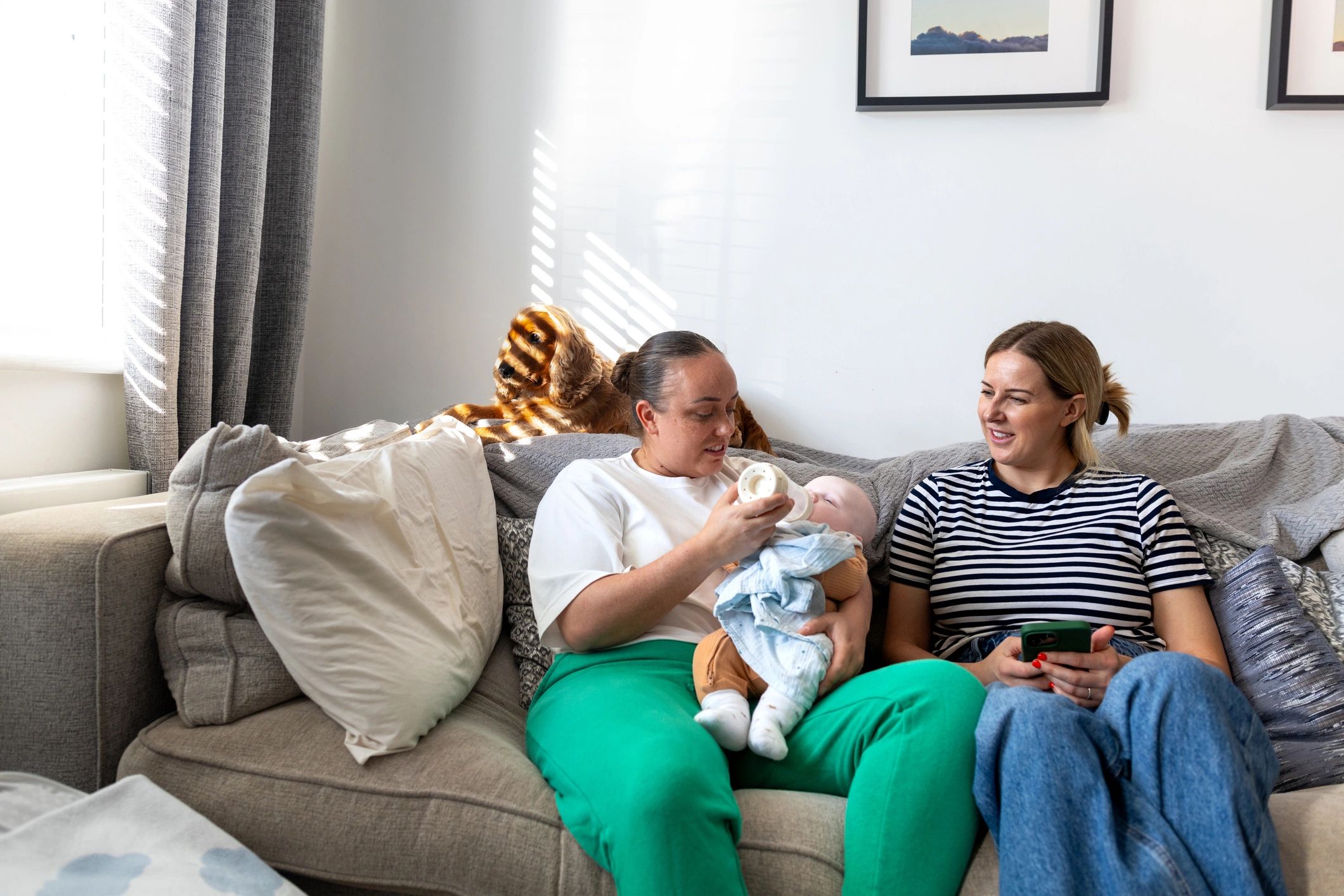 Parent holding newborn at home