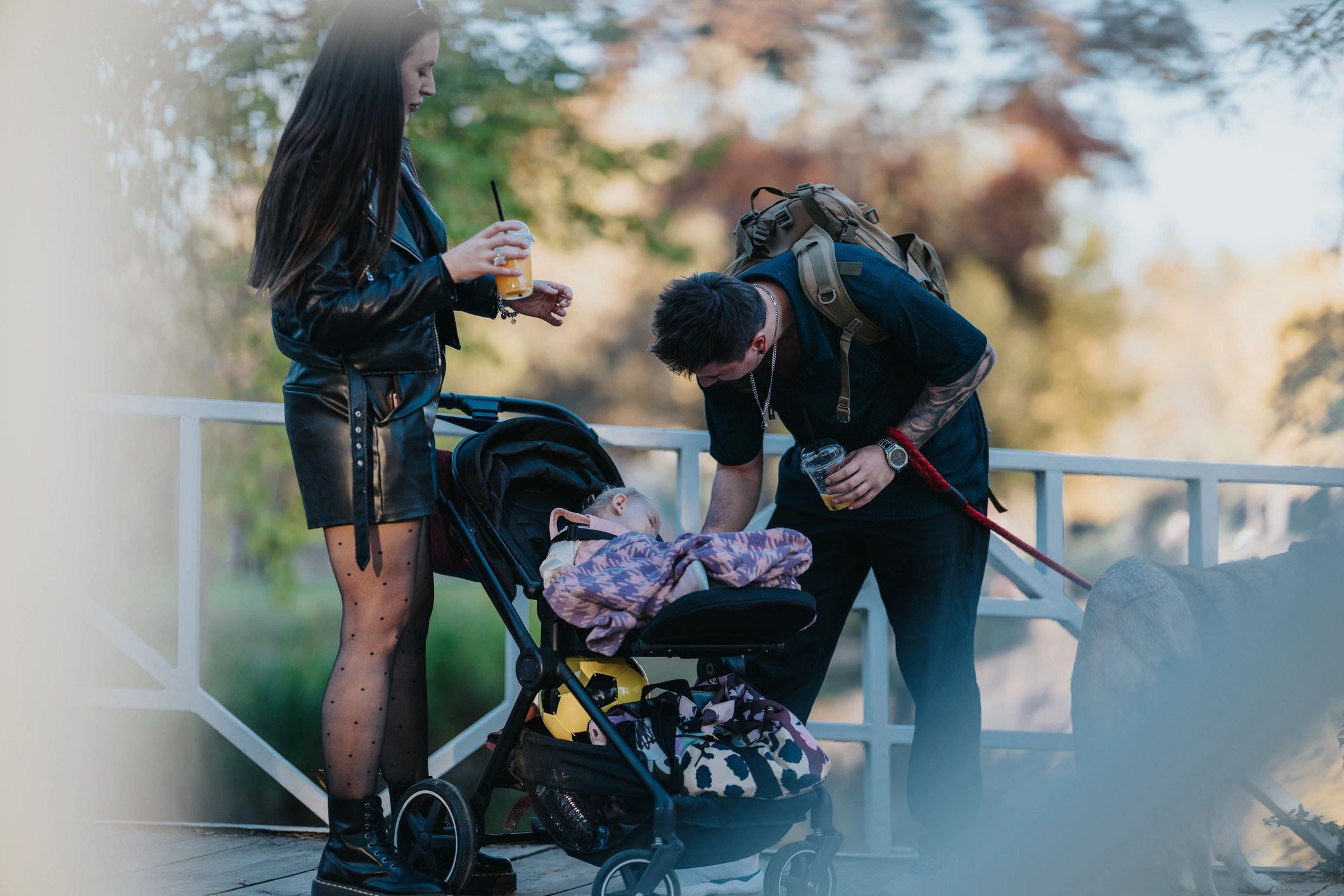 Family enjoying a park outing with a baby stroller